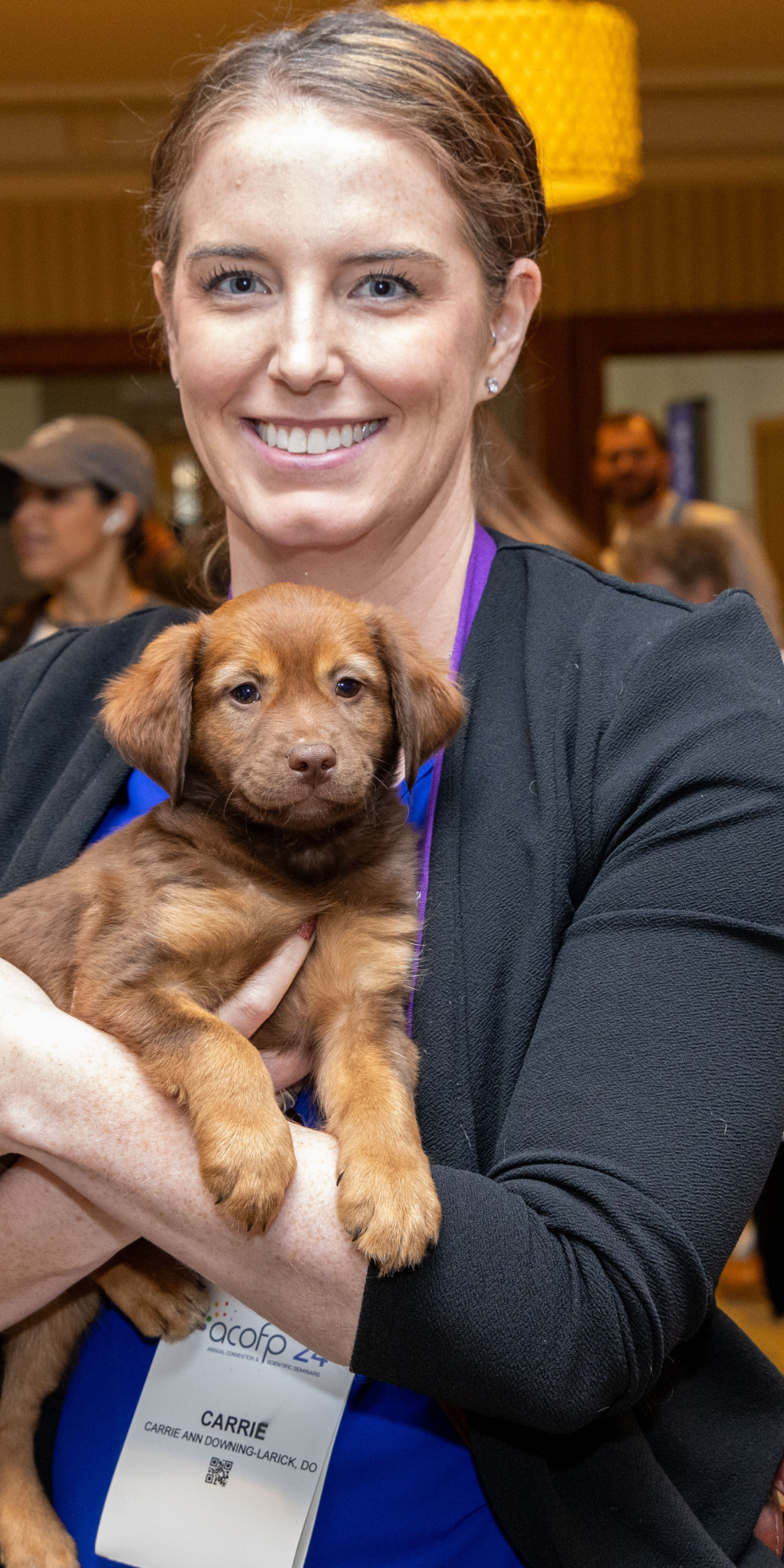 Woman holds puppy