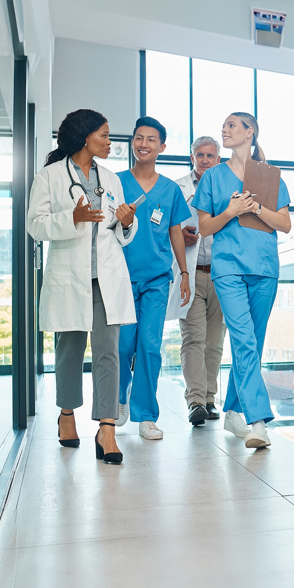 Group of physicians walking down hall in hospital