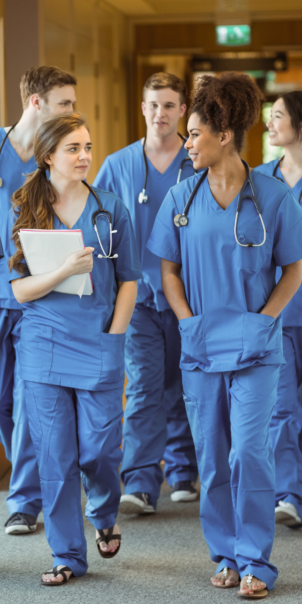 Colleagues Walking Down Hallway