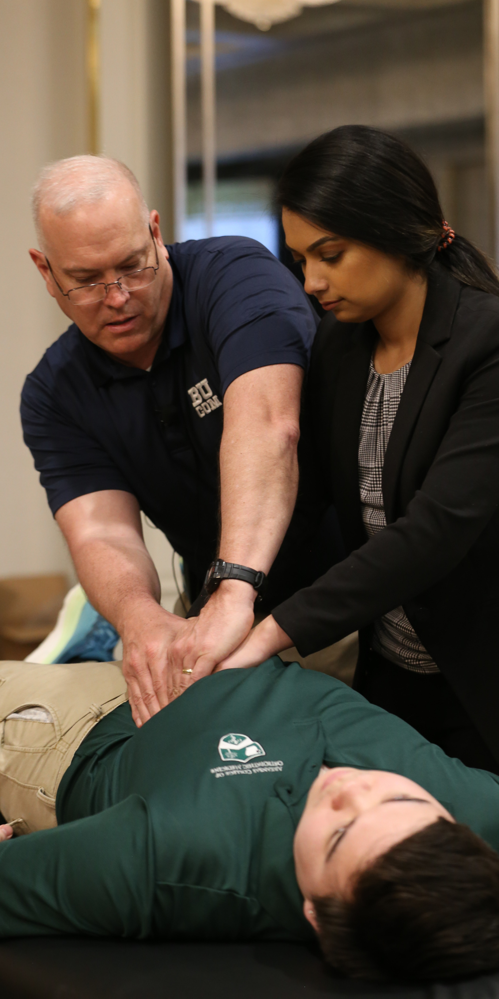 Man demonstrates osteopathic manipulative therapy on person