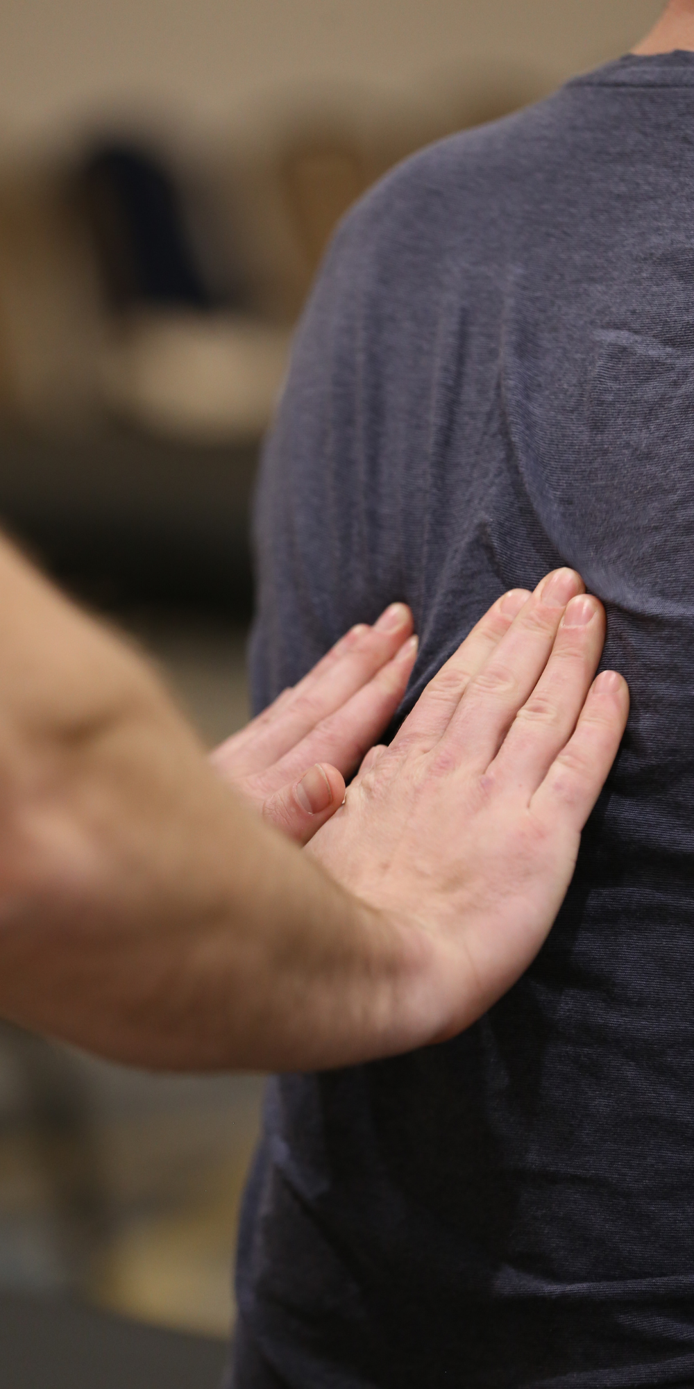 Man demonstrates osteopathic manipulative therapy on person