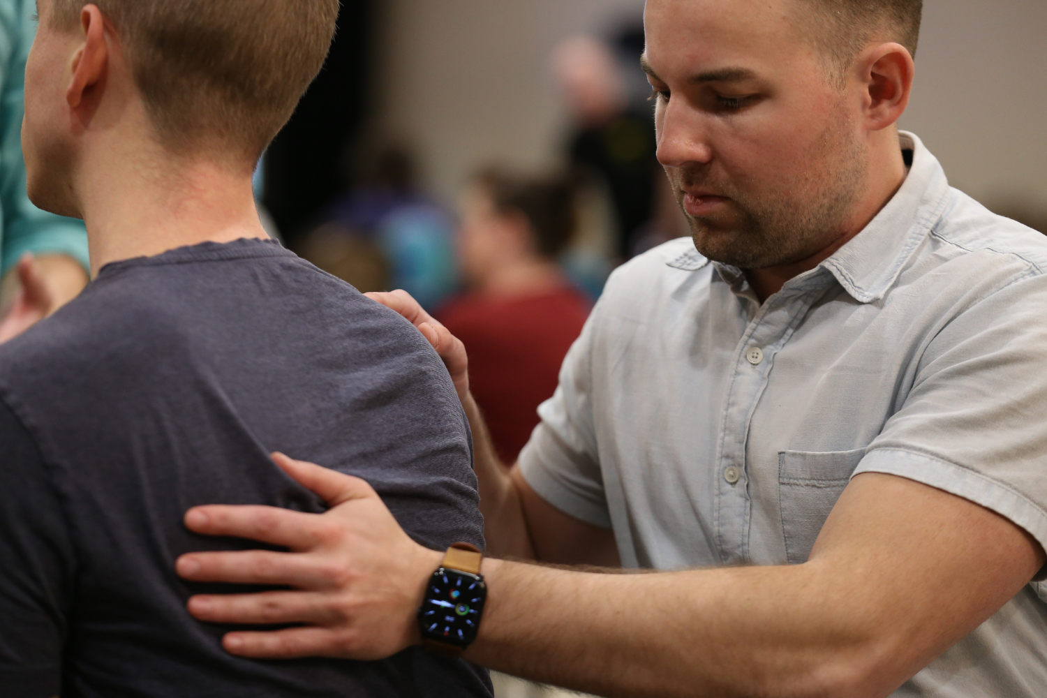 Man demonstrates osteopathic manipulative therapy on person