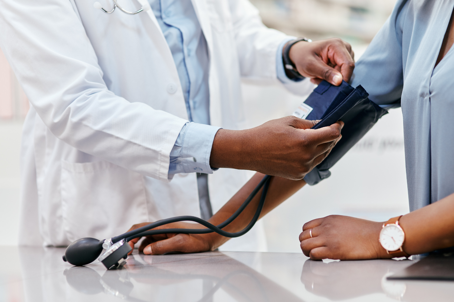 doctor takes blood pressure of patient