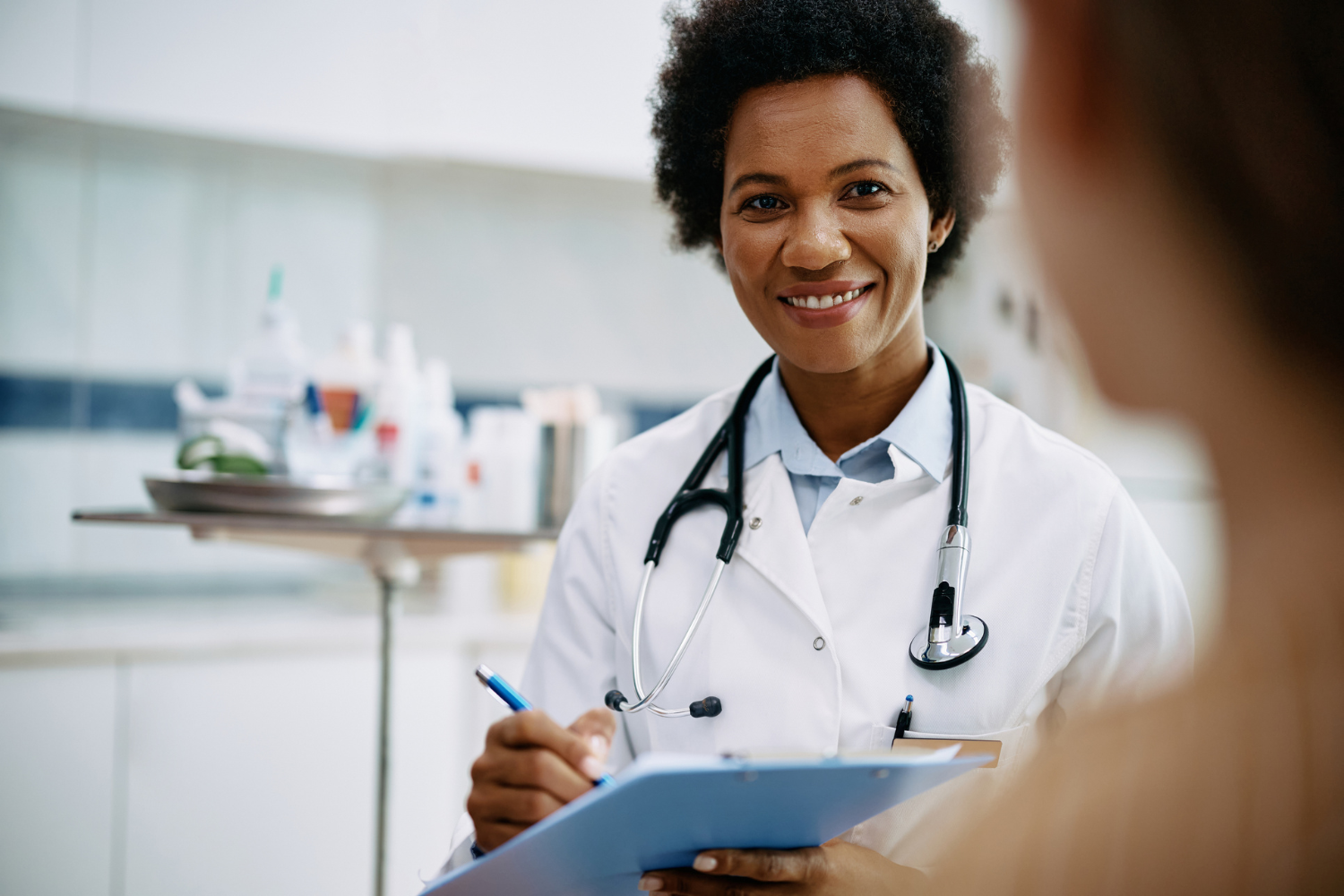 Smiling doctor with clipboard.